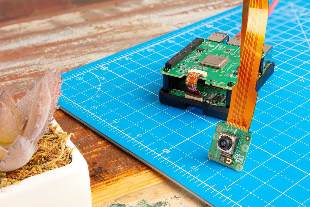 Raspberry Pi AI HAT+ stacked on a Raspberry Pi 5 with a camera module