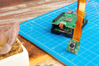 Raspberry Pi AI HAT+ stacked on a Raspberry Pi 5 with a camera module